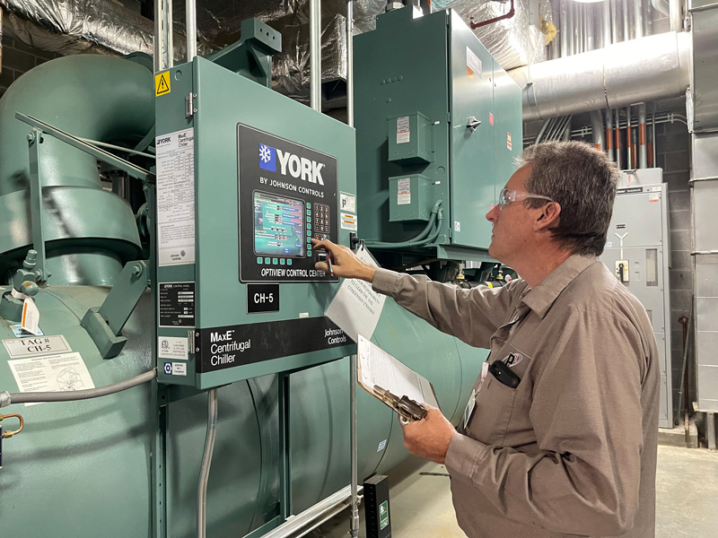 hvac technician inspecting systems