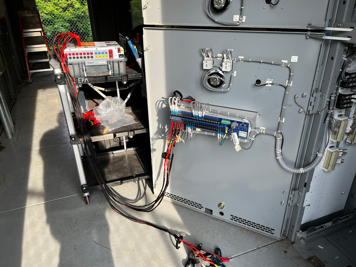 electrician repairing an energized electrical panel