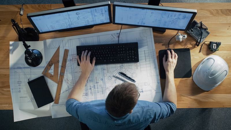 technician working on master planning on a computer