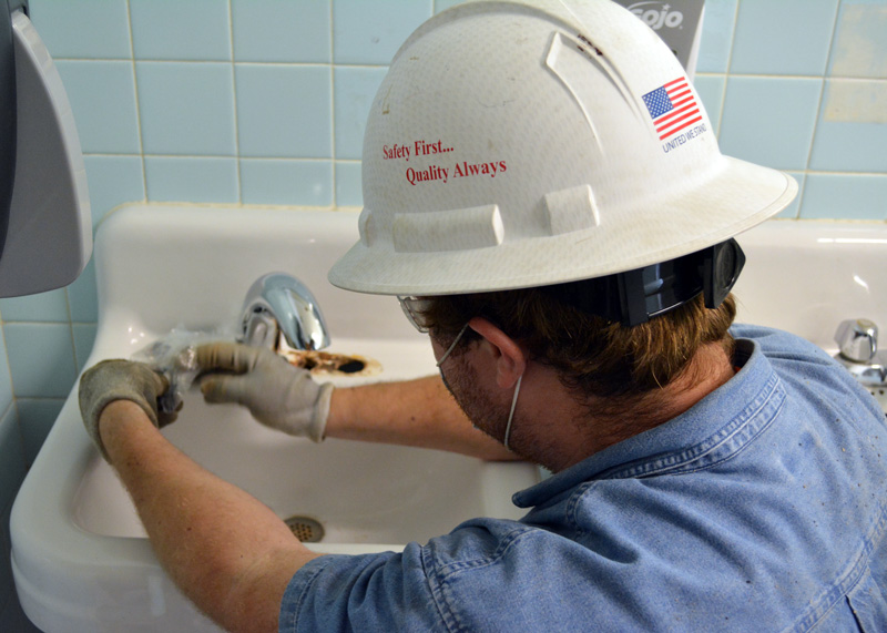 plumber inspecting complex piping