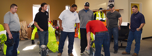 From left, Dan Shoemaker, Dan Holloway, Jamar Jackson, Ricky Rohaus, Lewis Ellington (from Schreiber Foods, a P1 customer) and Chad Moreland get a lesson on operating an oxygen tank.